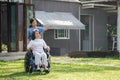 Elderly asian senior woman on wheelchair with nurse. Nursing home hospital garden concept. Royalty Free Stock Photo