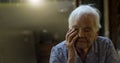 An elderly Asian woman with Alzheimer`s and memory loss sitting alone in house, Memory loss due to dementia Royalty Free Stock Photo