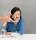 Elderly asian woman bored with food