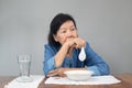 Elderly asian woman bored with food