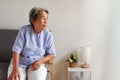 Elderly Asian woman with grey hair sitting lonely on the sofa, Aging society Sad and lonely concept, with copy space for text Royalty Free Stock Photo