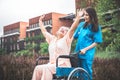 elderly Asian woman patient sitting on a wheelchair and female doctor Royalty Free Stock Photo