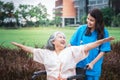 elderly Asian woman patient sitting on a wheelchair and female doctor Royalty Free Stock Photo