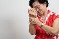 Elderly Asian woman patients suffer from numbing pain in hands from rheumatoid arthritis. Senior woman massage her hand with wrist