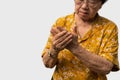 Elderly Asian woman patients suffer from numbing pain in hands from rheumatoid arthritis. Senior woman massage her hand with wrist Royalty Free Stock Photo