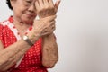 Elderly Asian woman patients suffer from numbing pain in hands from rheumatoid arthritis. Senior woman massage her hand with wrist Royalty Free Stock Photo