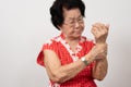 Elderly Asian woman patients suffer from numbing pain in hands from rheumatoid arthritis. Senior woman massage her hand with wrist Royalty Free Stock Photo