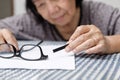 Elderly asian woman repair broken glasses Royalty Free Stock Photo