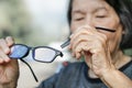 Elderly asian woman repair broken glasses Royalty Free Stock Photo