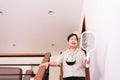 Elderly asian woman using mosquito swatter at home,Elderly women with mosquito electric net racket