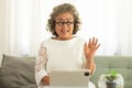 Elderly Asian woman video conferent online with teblet at home Royalty Free Stock Photo