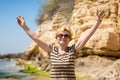 Elderly attractive woman walking along the beach and showing her palm hands Royalty Free Stock Photo