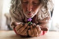 Elderly bearded man holding a flower in his hands Royalty Free Stock Photo