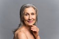 Elderly and beautiful gray-haired woman isolated on gray Royalty Free Stock Photo