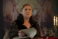 Elderly beautiful woman with an old book