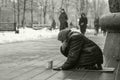 Elderly beggar woman on the street asking for money. Beggars. Social problem. Black and white