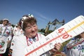 An elderly Belarusian or Ukrainian grandmother in national clothes holds a toy thermometer with a temperature of forty