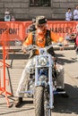 An elderly biker on a motorcycle.