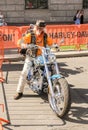 An elderly biker on a motorcycle.