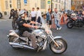 An elderly biker on a silvery bike.