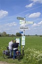 Elderly bikers reading road map in countryside Royalty Free Stock Photo