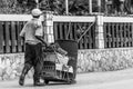Elderly black man pushing cart in the street