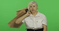 An elderly bored woman with shopping bags. Shopping. Presents. Chroma key