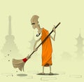 Elderly Buddhist monk sweeps the courtyard of the monastery