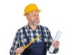 Elderly builder holding utensils