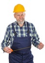 Elderly builder holding utensils