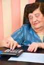 Elderly business woman calculating