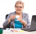 Elderly business woman drinking tea or coffee at desk in office, break at work Royalty Free Stock Photo