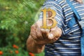 Elderly Businessman choosing bitcoins on the touch screen in the global network. The concept of distribution of bitcoins. Concept