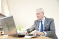 Elderly businessman working laptop Royalty Free Stock Photo