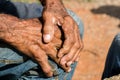 Elderly callous hands of a Latin man resting one upon the other