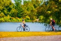 Elderly Canadian couple riding bicycle near the pond in Rapids park, Montreal, Canada