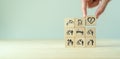 Elderly care concept. Hand holds wooden cubes with icons related to elderly care, medical, rehabilitation service, nursing care fo