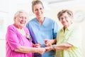 Elderly care nurse with two senior women Royalty Free Stock Photo