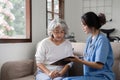 Elderly caregivers are helping to check the health and care for an elderly woman at home. Royalty Free Stock Photo