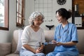 Elderly caregivers are helping to check the health and care for an elderly woman at home. Royalty Free Stock Photo