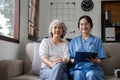 Elderly caregivers are helping to check the health and care for an elderly woman at home. Royalty Free Stock Photo