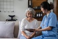 Elderly caregivers are helping to check the health and care for an elderly woman at home. Royalty Free Stock Photo