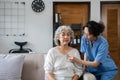 Elderly caregivers are helping to check the health and care for an elderly woman at home. Royalty Free Stock Photo