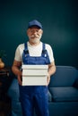 Elderly cargo man in uniform poses in home office