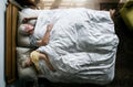 Elderly Caucasian couple sleeping on the bed