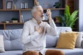 Senior man using inhaler during asthma attack at home Royalty Free Stock Photo