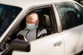 Elderly caucasian man sitting in car and using phone. active modern pension people