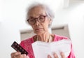 Elderly caucasian woman with medicine and reading drug prescript