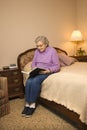 Elderly Caucasian woman reading book.