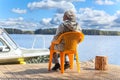 Elderly Caucasian woman relaxing at lake on pier Royalty Free Stock Photo